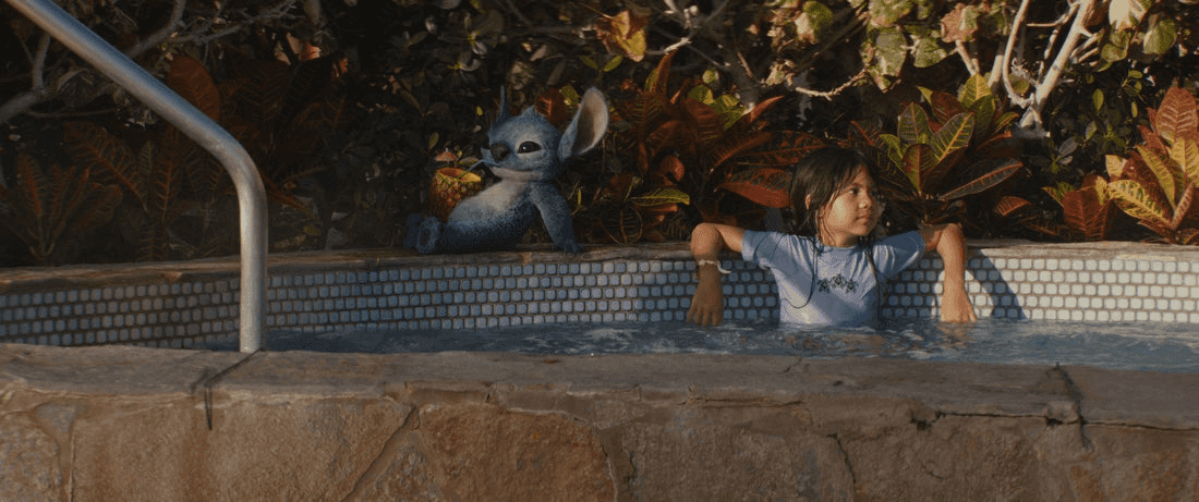 (L-R) Stitch and Maia Kealoha as Lilo in Disney’s live-action LILO & STITCH. Photo courtesy of Disney. © 2025 Disney Enterprises Inc. All Rights Reserved.